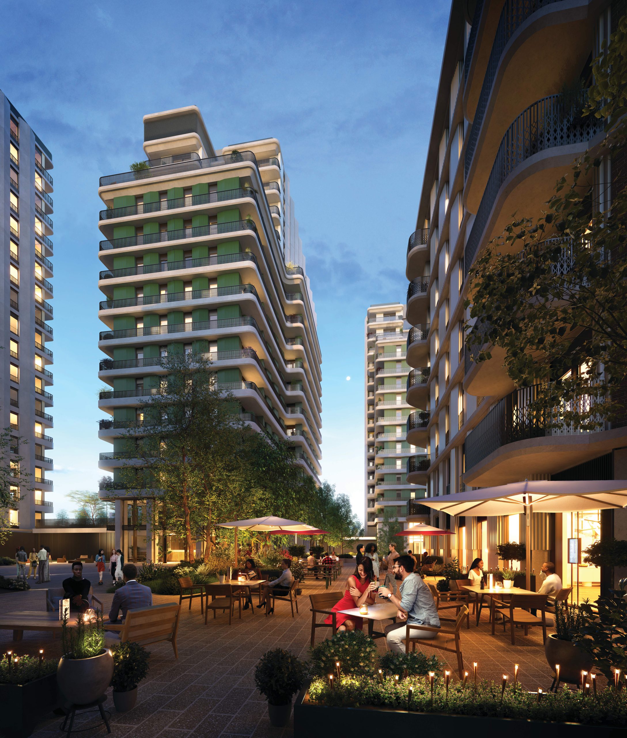 Dusk CGI of the Ebury phase one development, showing communal outside areas with people sitting at cafe tables enjoying a drink.