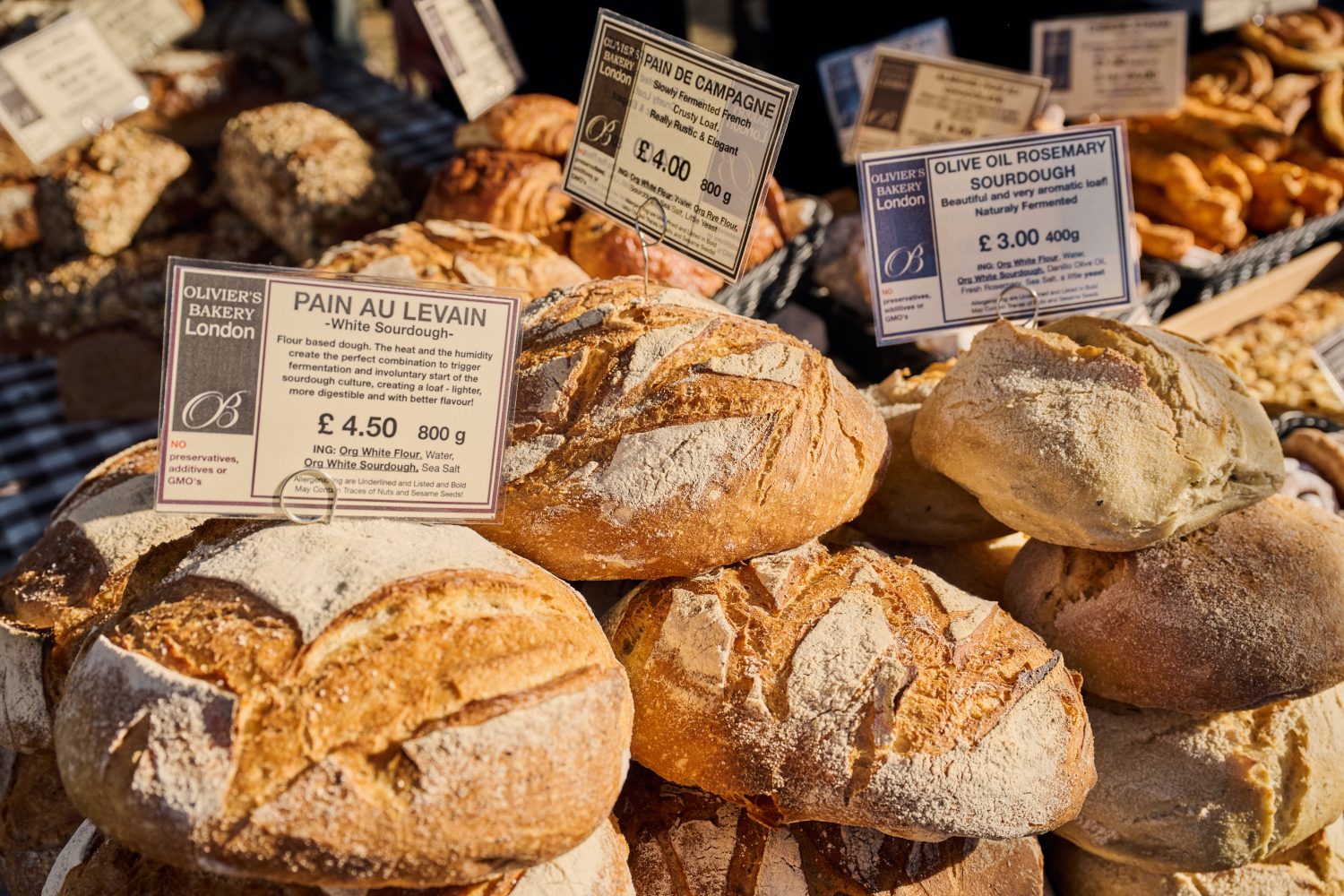 A close up view of an attractive display of rustic bread loaves at the market