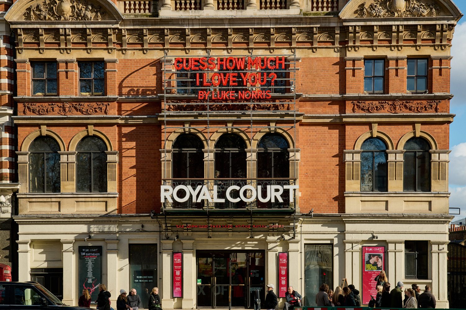 Exterior of the red-brick Royal Court theatre with people queuing outside