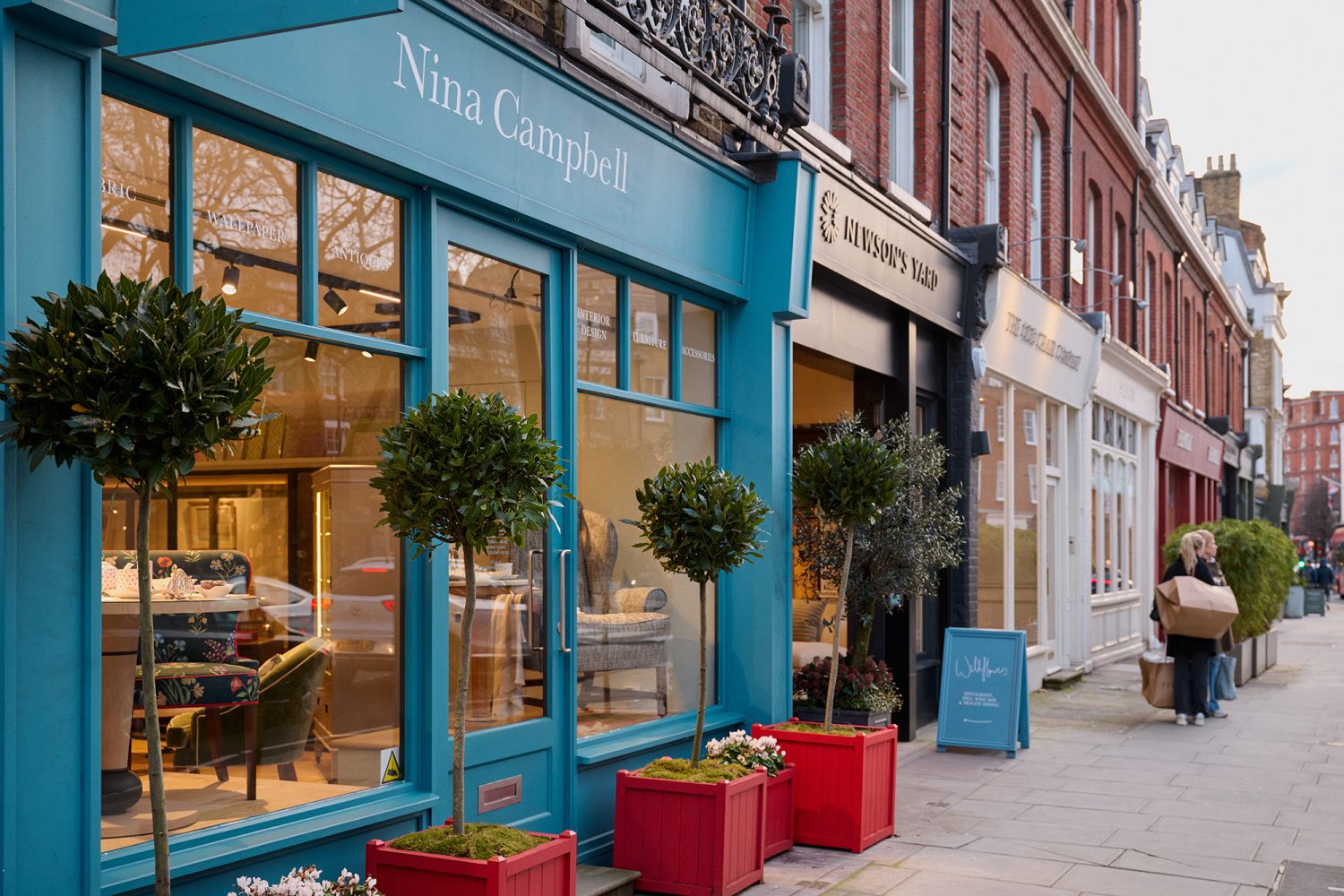 Shop fronts of interior design boutiques along Pimlico Road with Nina Campbell's shop in the forefront.