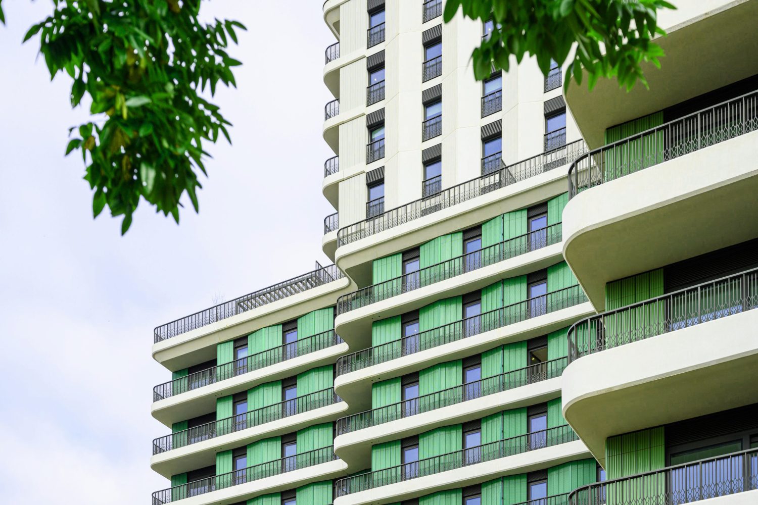 Exterior section of new apartment building at Ebury showing distinctive curved architecture and green facade detail